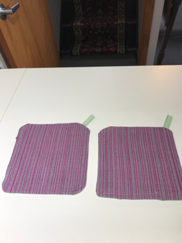 Karen Y, using handwoven leftovers for hot pads. Dyed, woven and fabrics.